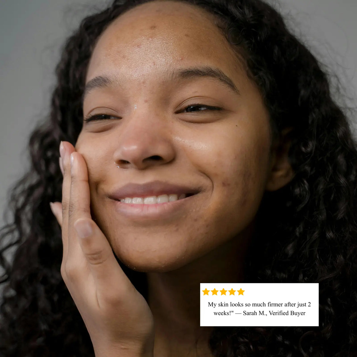 Woman with a smile on her face, holding her hand to her cheek, with a product review overlay.